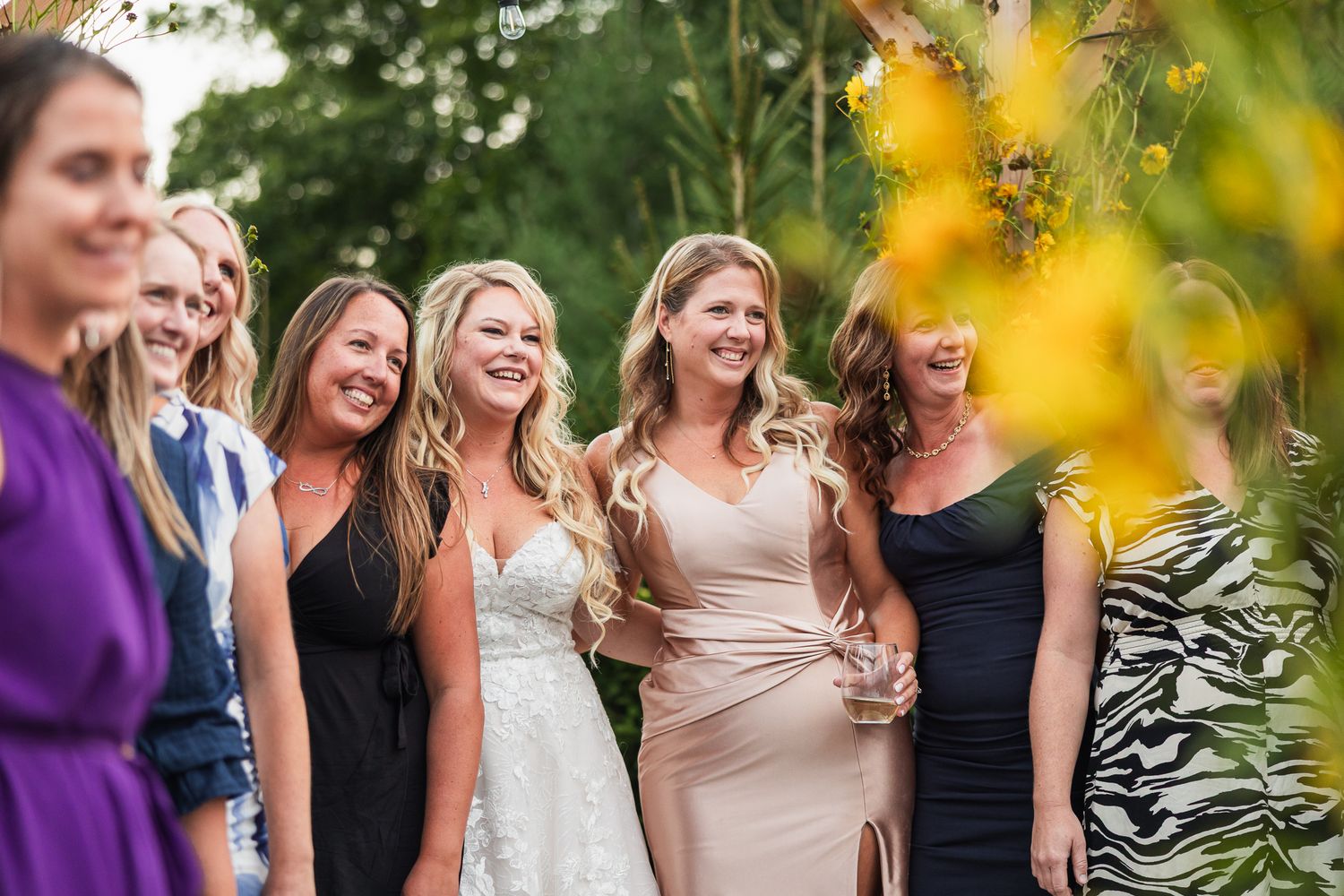 Group photo in a garden setting with natural sunlight filtering through yellow foliage.