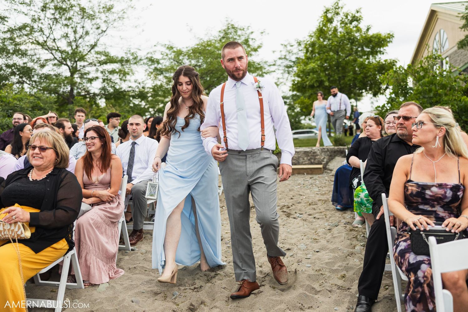 Wedding guests enjoying themselves at a casual beach reception.