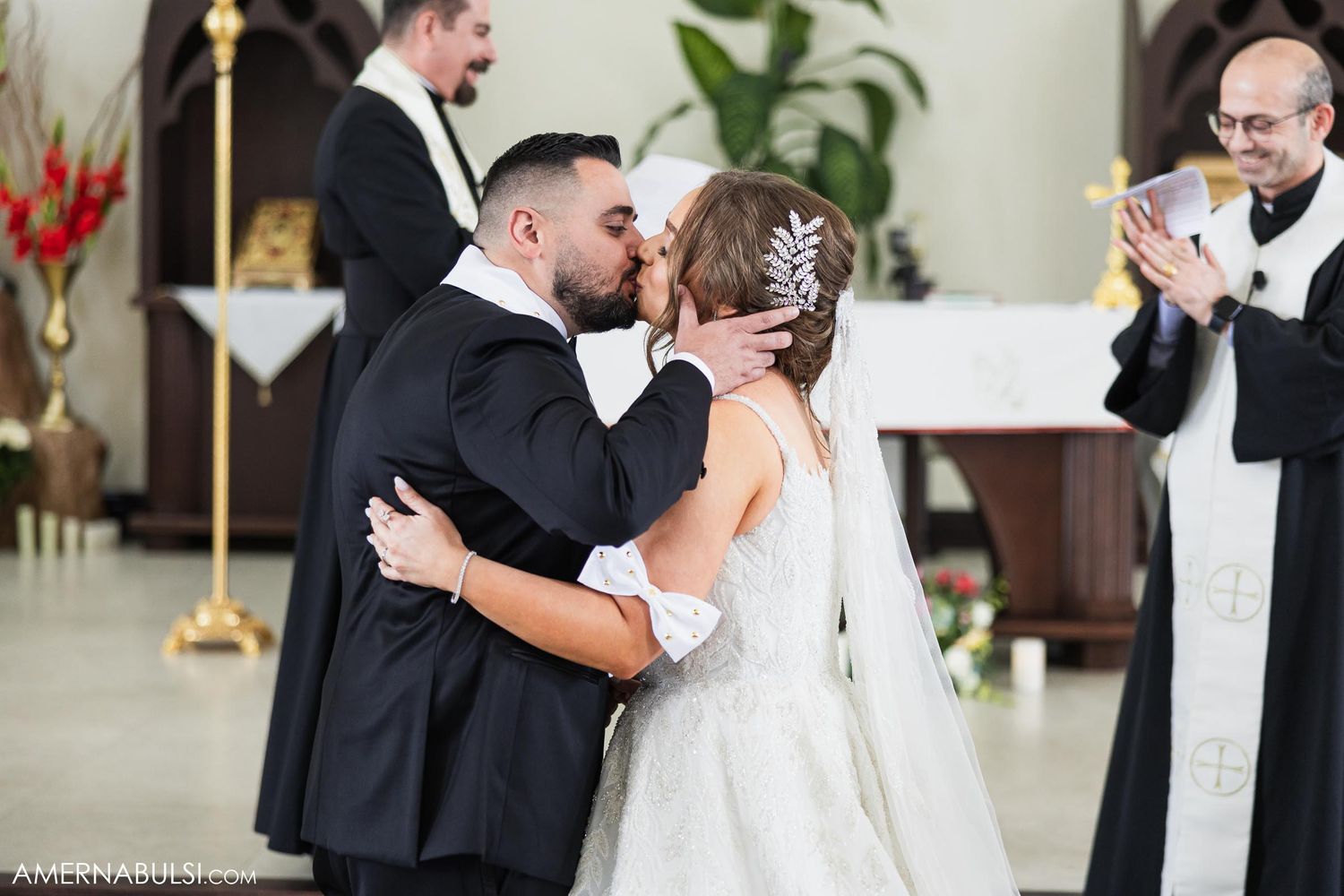 Romantic moment shared during traditional Catholic church wedding ceremony.