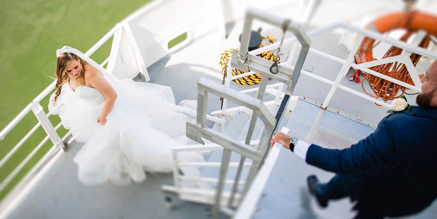 Wedding reception table settings with elegant white decor and floral arrangements.