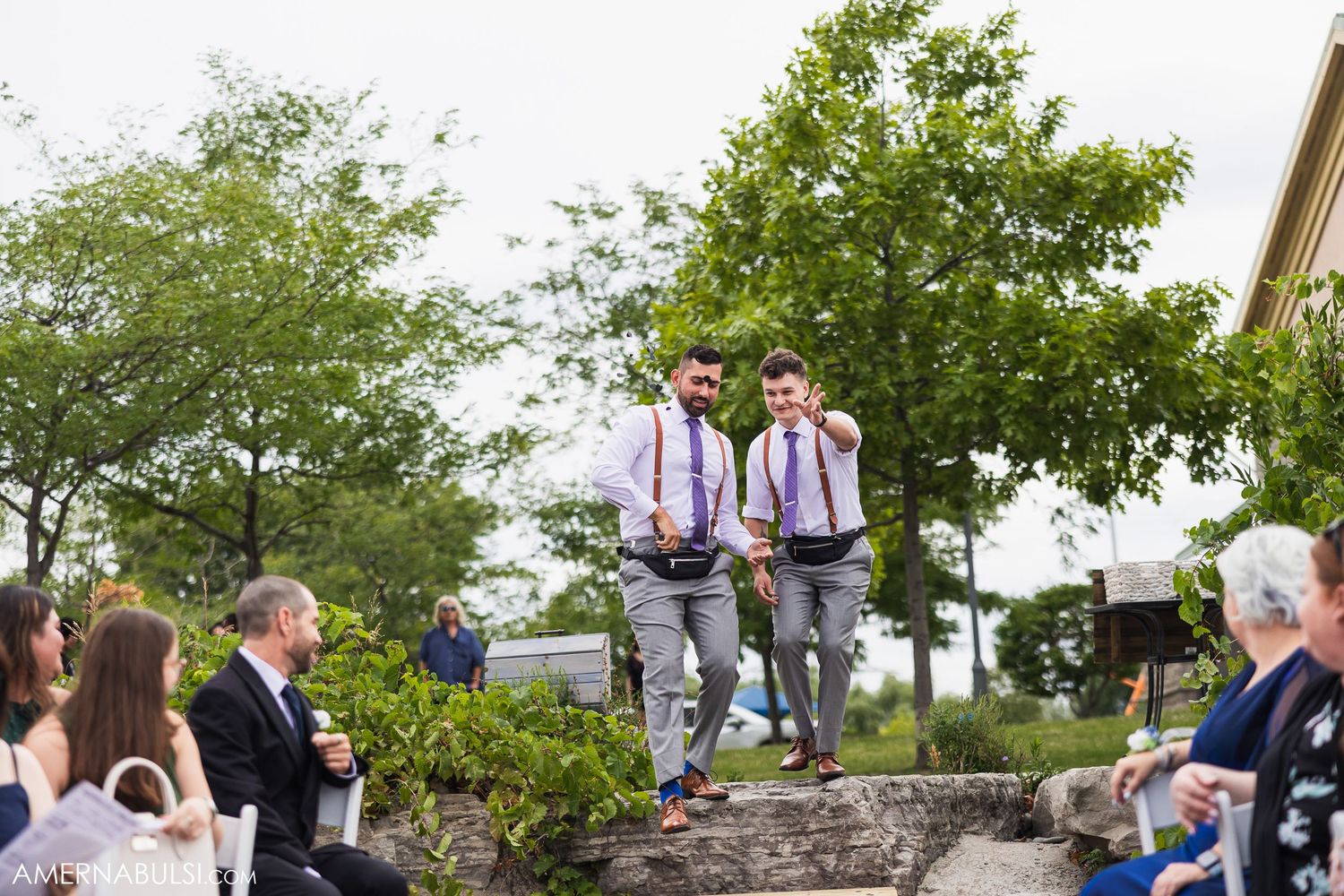 Wedding celebration candid moments captured in an outdoor garden setting with guests mingling.