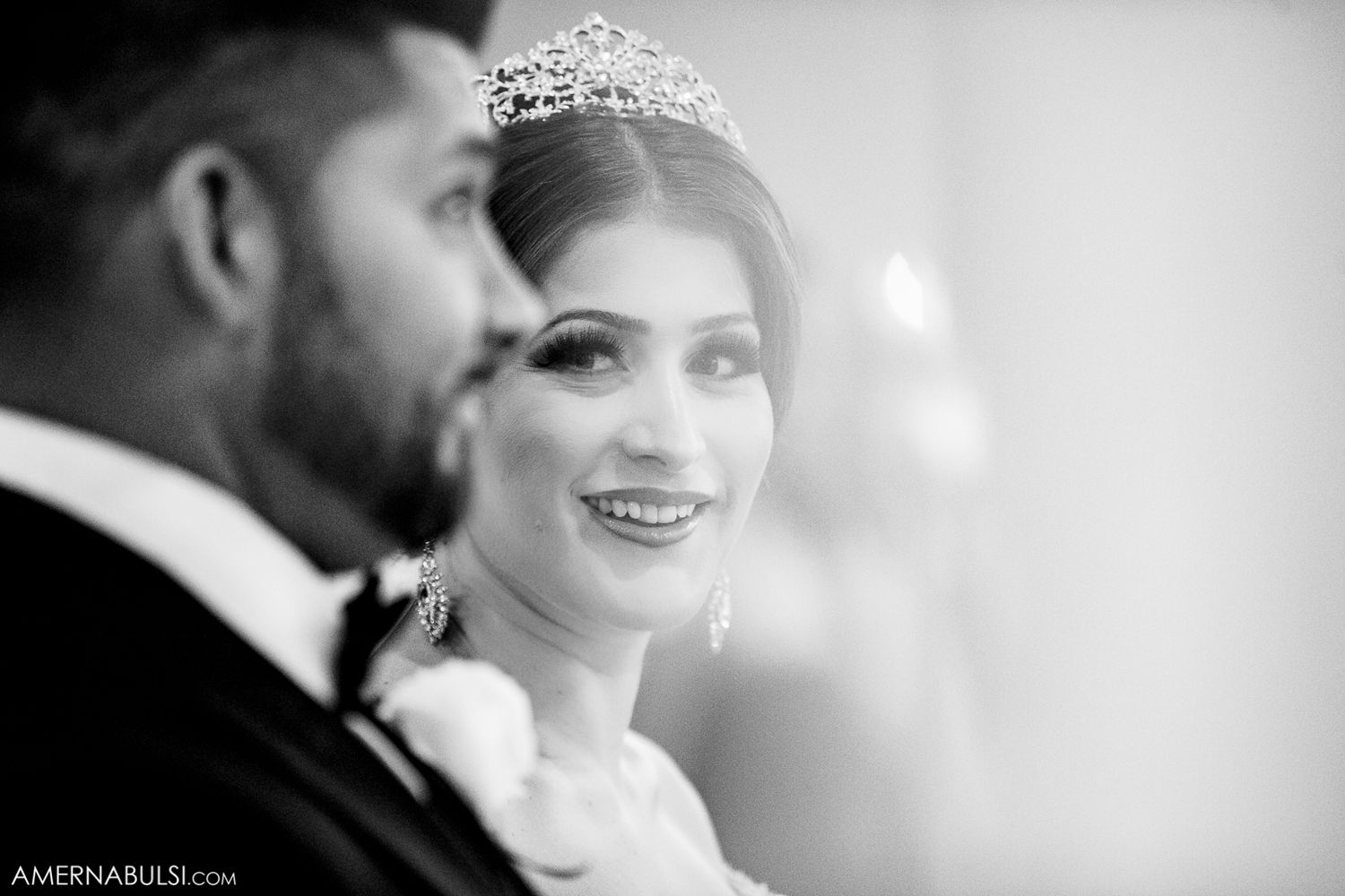 Black and white artistic wedding portrait capturing tender moments between newlyweds.