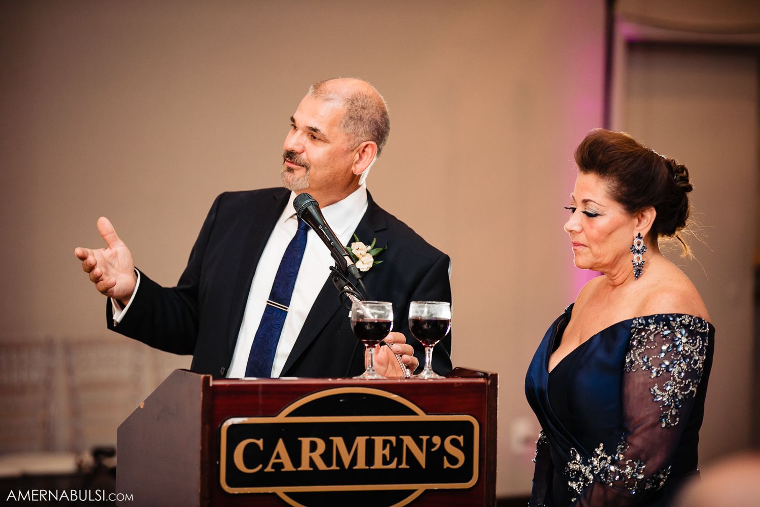 Wedding reception venue interior showing Carmen's signage and elegant table settings.