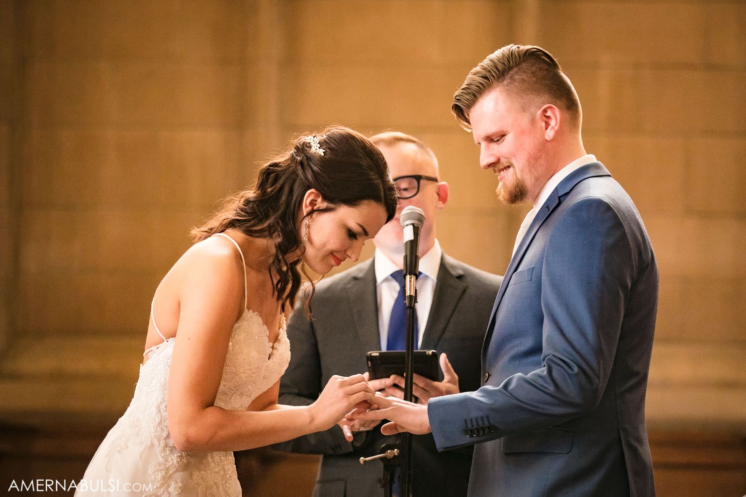 Intimate wedding ceremony moment captured in warm golden lighting.