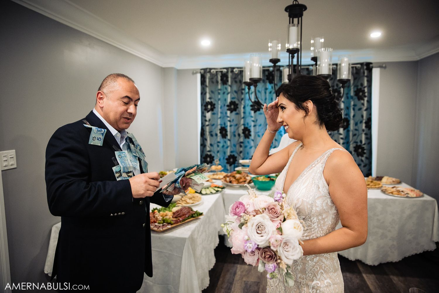 Wedding couple and guests enjoy refreshments and appetizers at indoor reception.