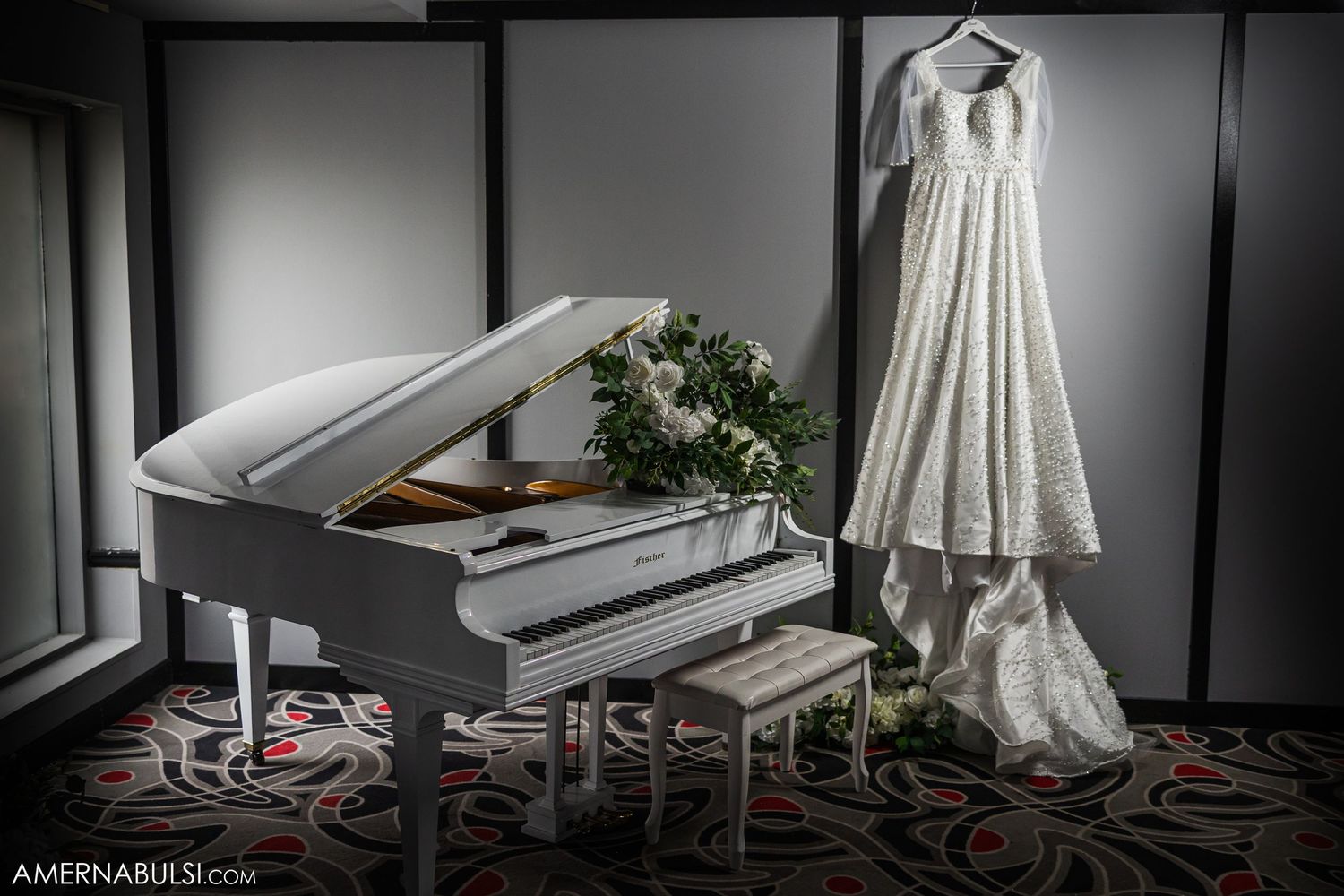 Wedding dress and accessories displayed in dramatic lighting against dark backgrounds.