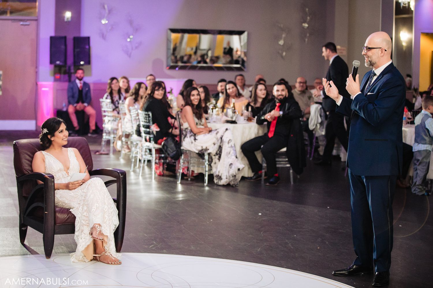 A reception scene shows seated guests watching a speaker in a modern venue with purple lighting.