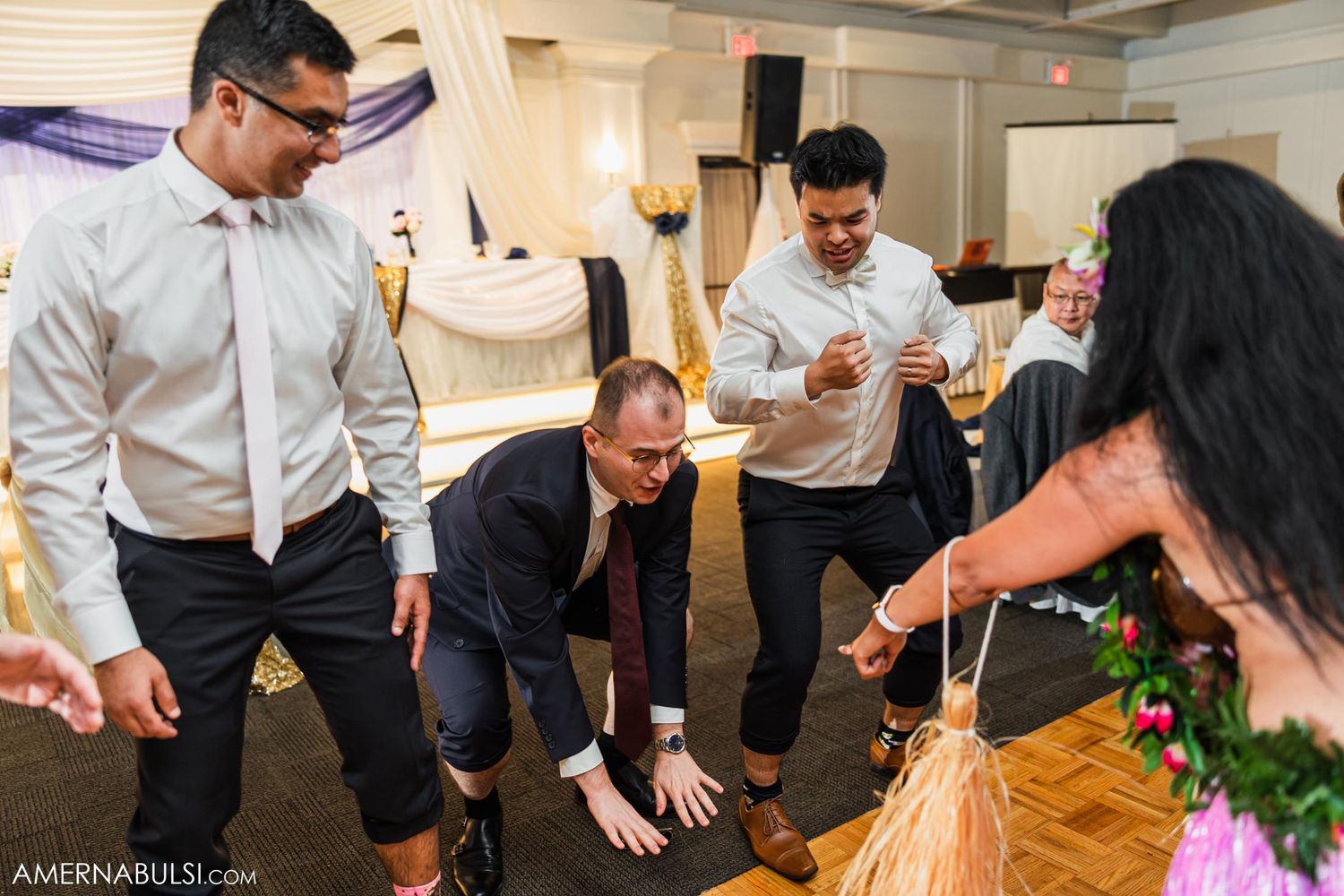 Wedding guests dancing energetically at a reception.