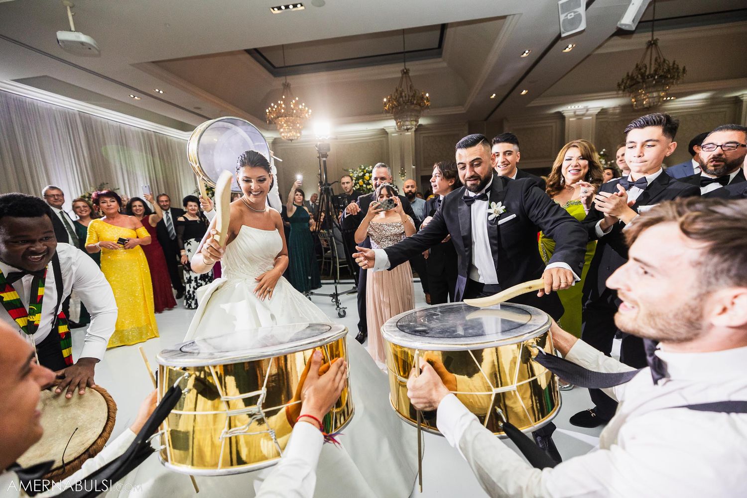 Energetic wedding reception with live drumming entertainment and dancing guests.
