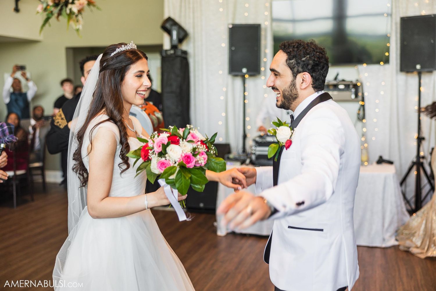 A newlywed couple shares a joyful moment dancing together at their wedding reception.