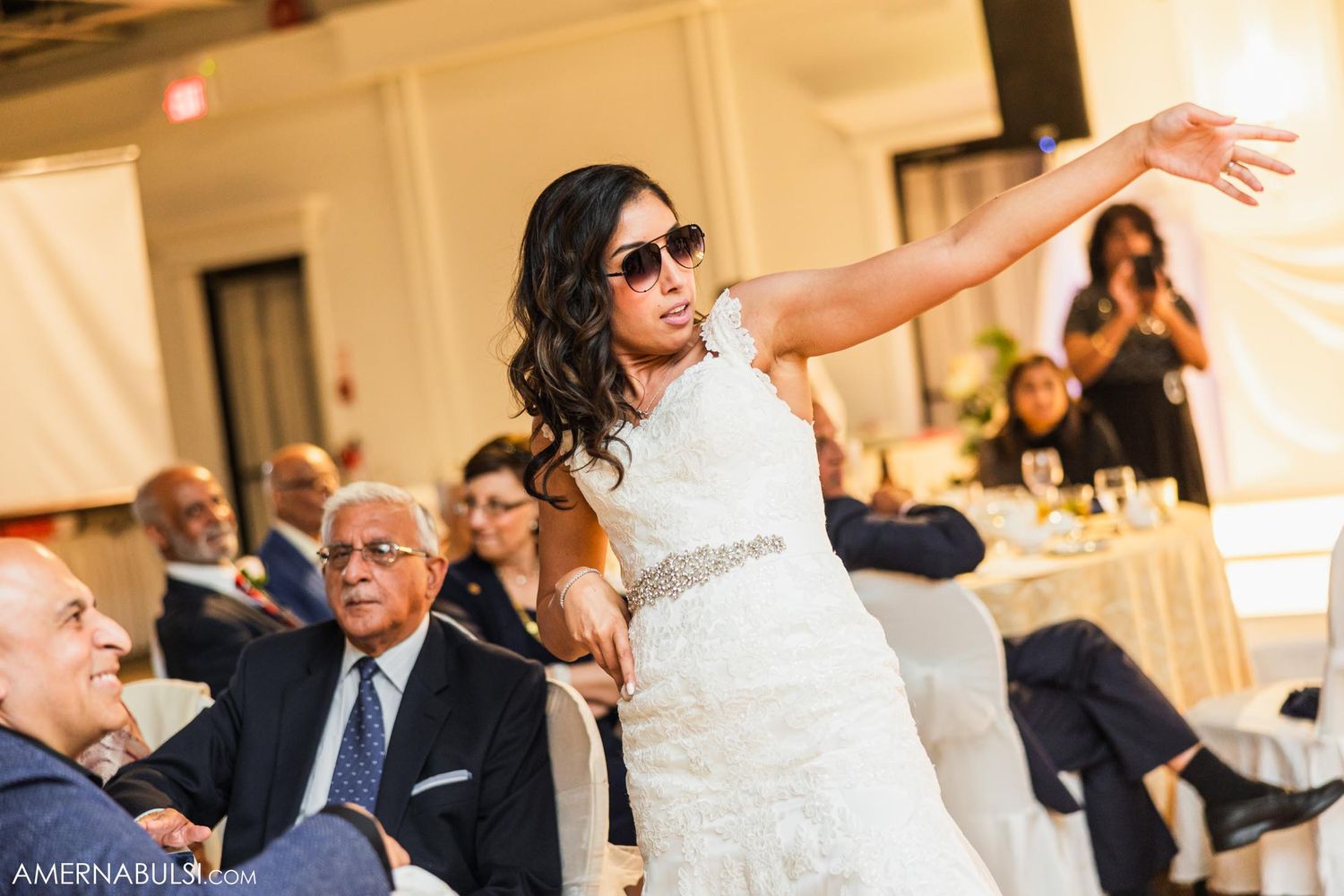 A celebratory dance moment at an elegant indoor wedding reception.