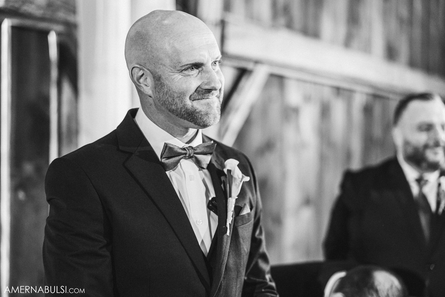 Black and white portrait of a formally dressed person wearing a bowtie and suit.