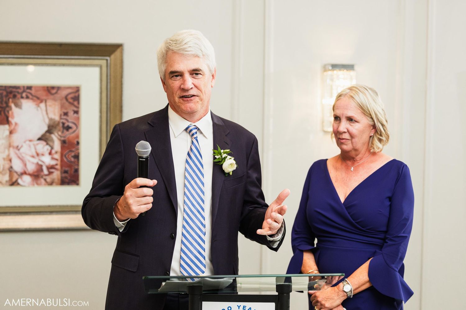 Speakers share heartfelt moments during elegant wedding reception.