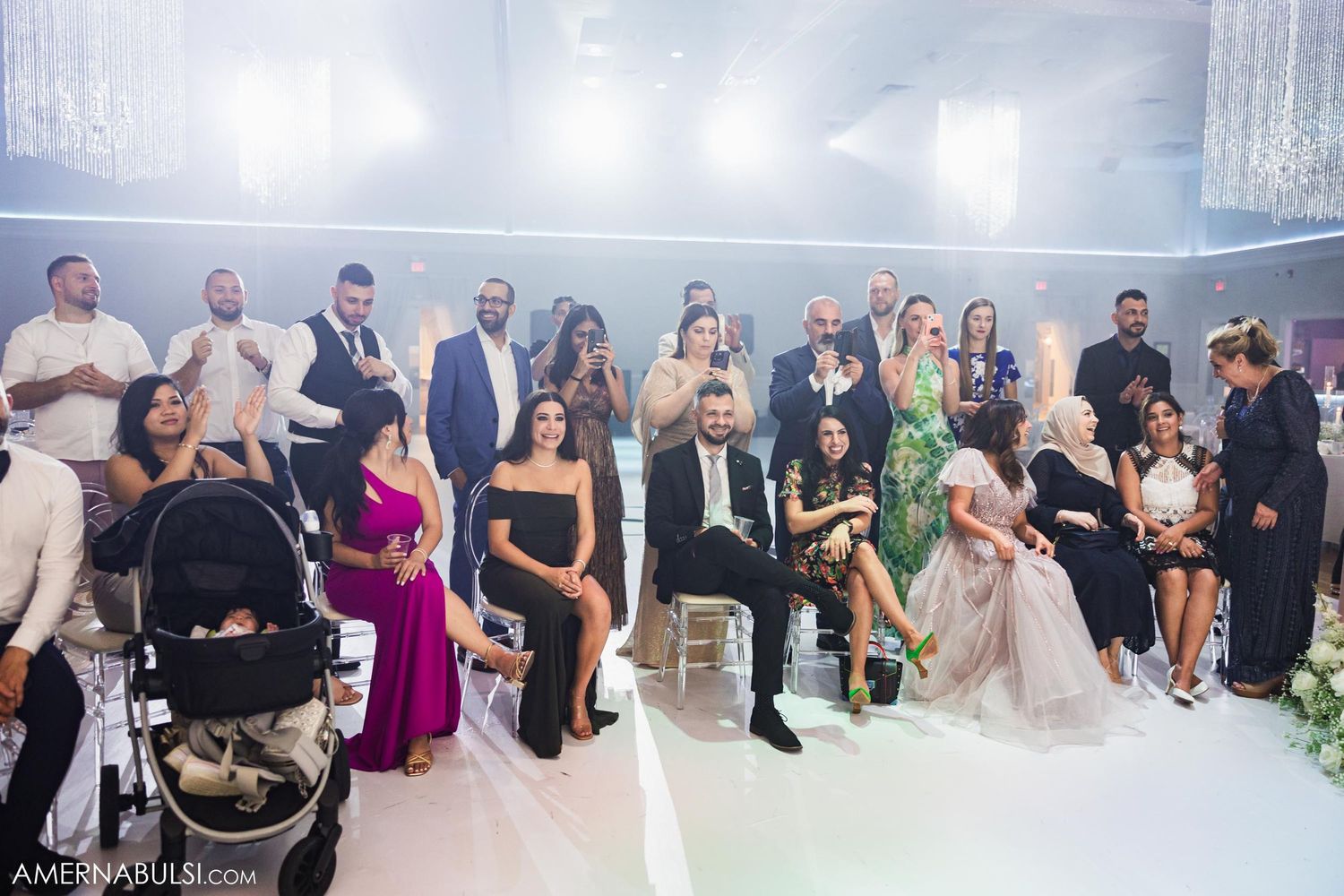 Wedding reception scene with guests seated in elegant event space.