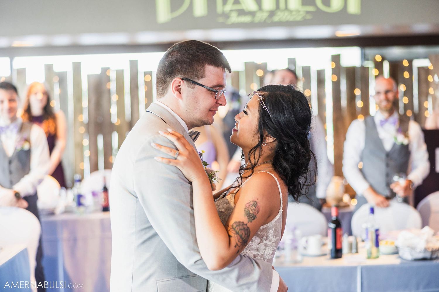 A tender slow dance moment at an elegantly decorated wedding reception venue.