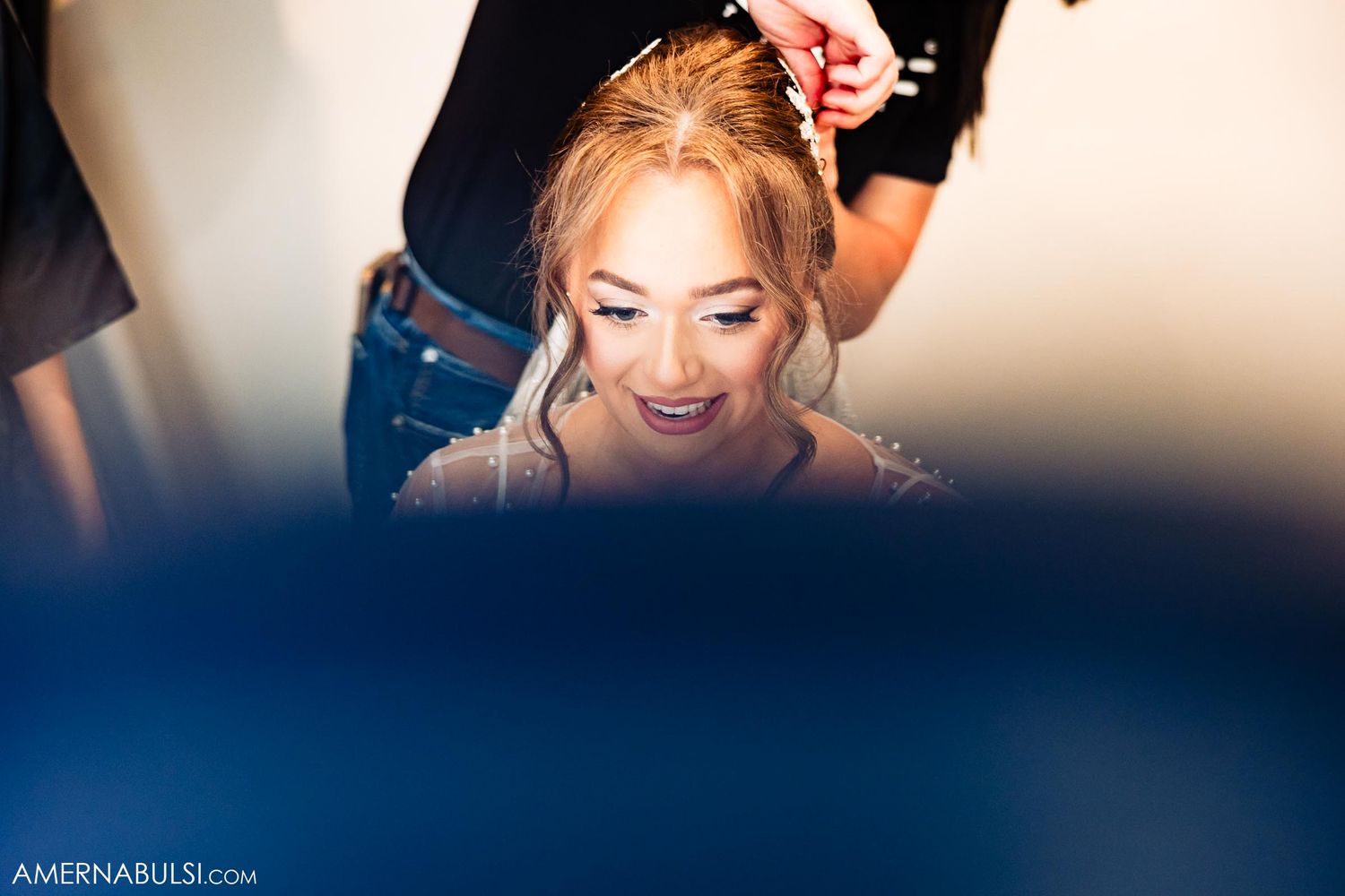 Soft lighting creates an intimate atmosphere during wedding day preparations.