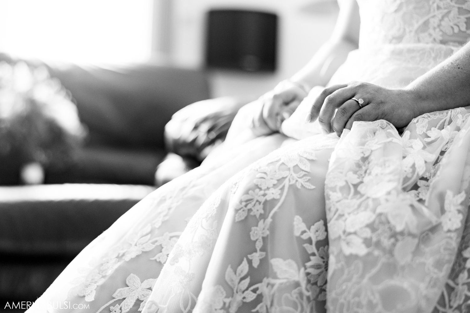 Close up detail of white lace wedding dress fabric and beading in black and white.