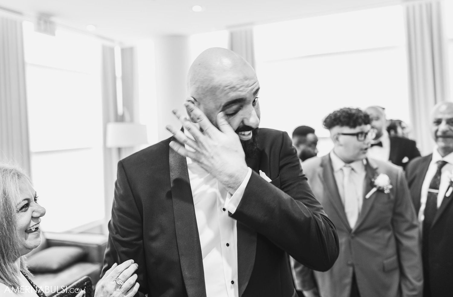Emotional moment captured in black and white during wedding celebration.