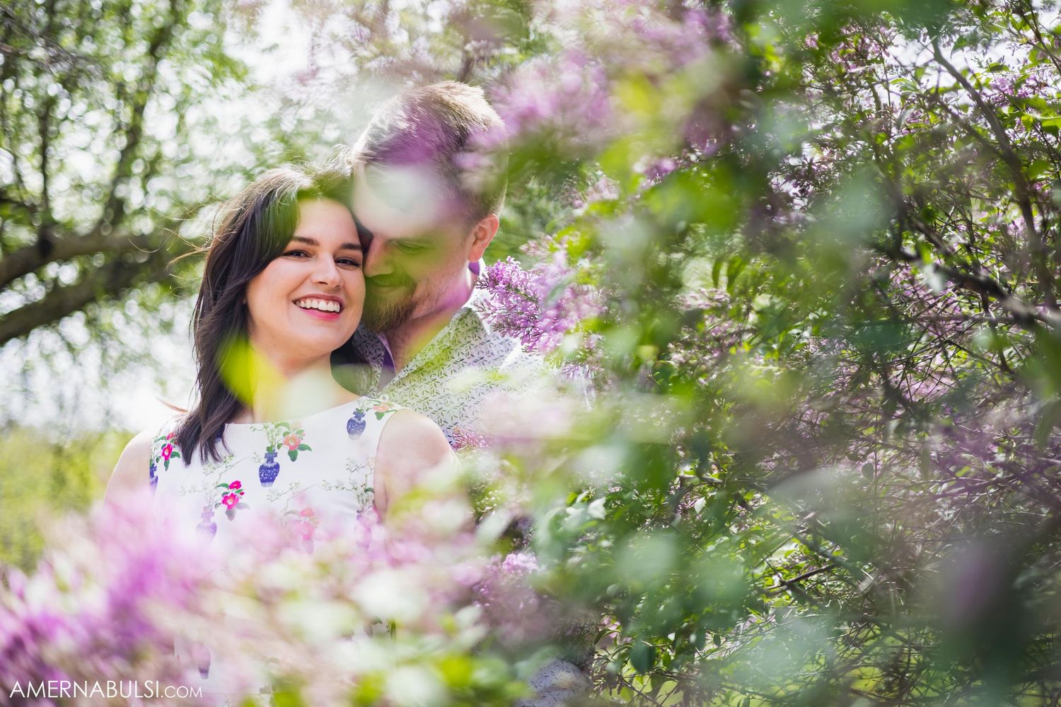 A romantic moment captured among blooming purple flowers in springtime.