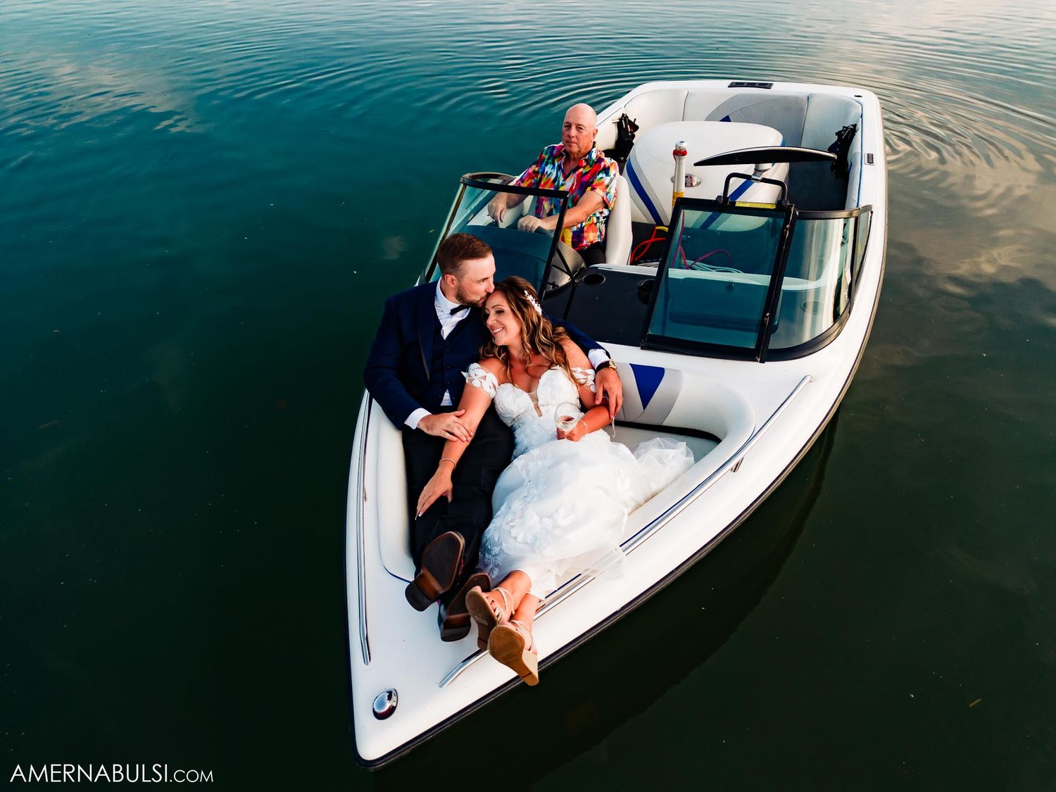 Aerial view of a couple enjoying a romantic moment on a white boat.