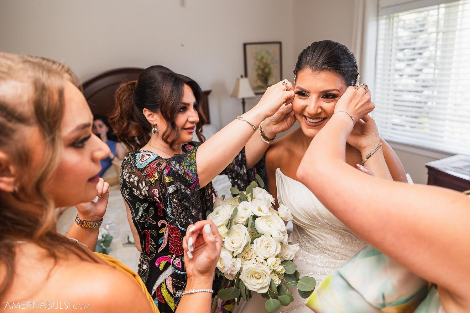 A joyful candid moment showing emotional wedding preparation with white bouquet.