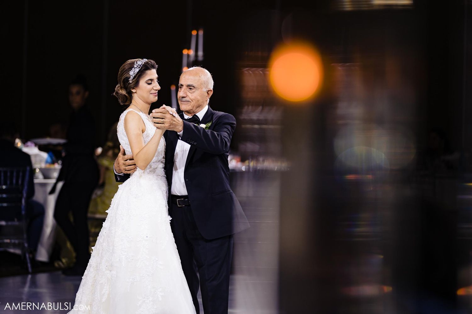 A tender dance moment captured during an elegant wedding reception.