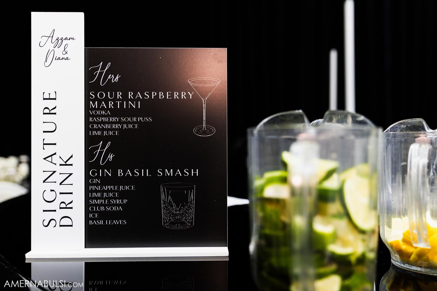 Cocktail menu display with signature drink list and garnished beverages on dark background.