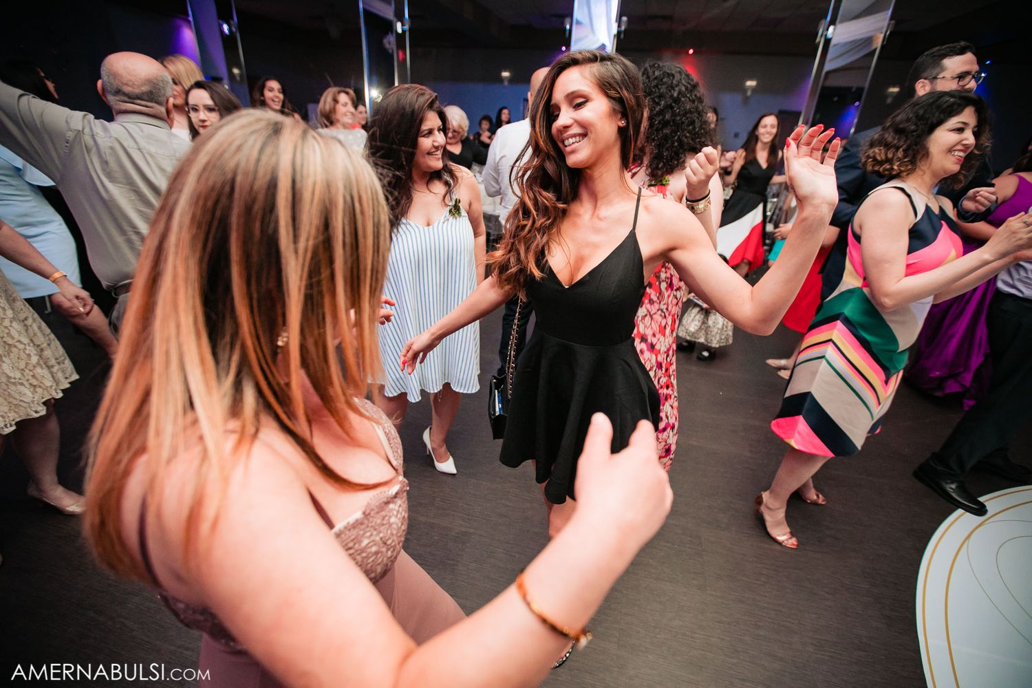 A group of people dancing and celebrating at a lively party or nightclub event.