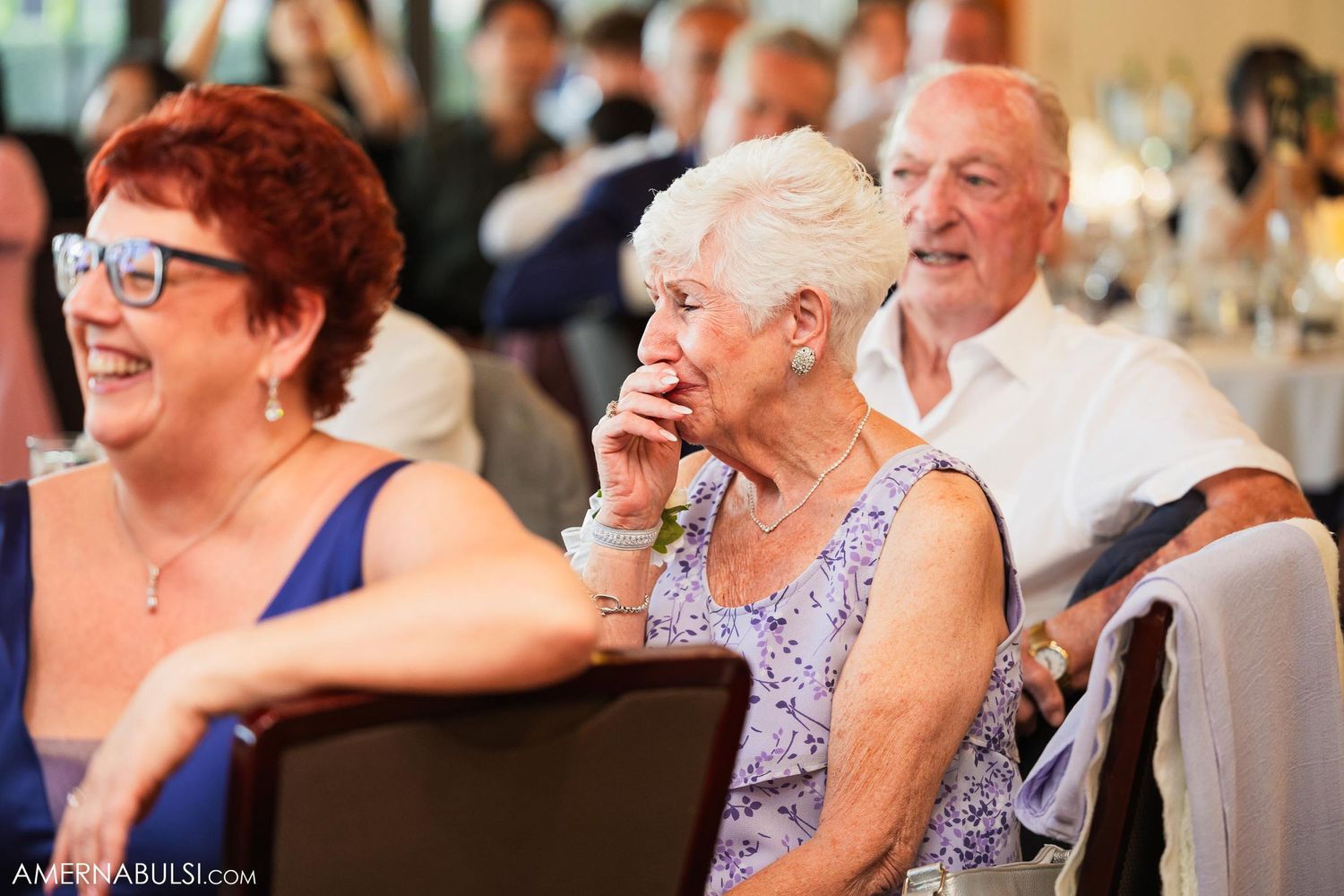 Wedding reception guests share joyful moment during celebration.