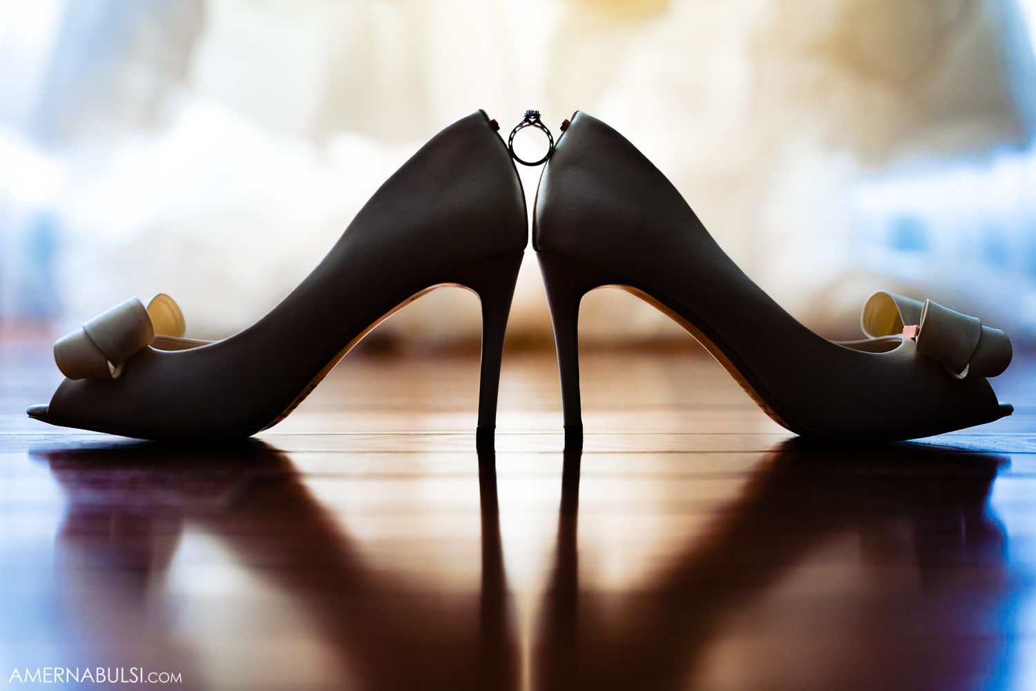 Silhouette of elegant bridal shoes against a backlit window.