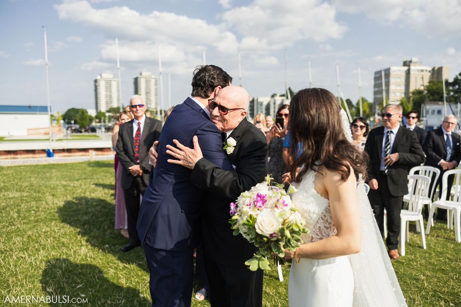 A joyful moment between newlyweds during their waterfront wedding ceremony.