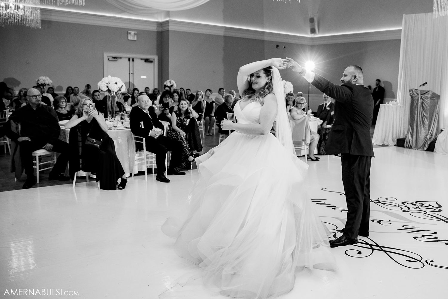 Black and white photos showing a wedding dance sequence with flowing white dress movements on a ballroom floor.