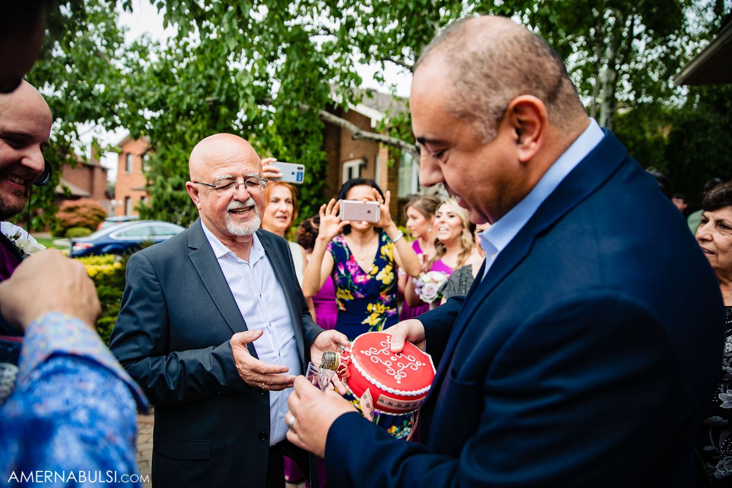 A joyful outdoor wedding gathering with guests sharing laughter and conversation.