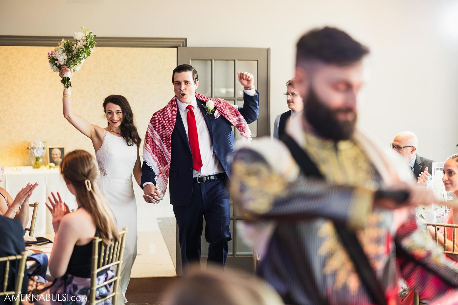 Wedding celebration features enthusiastic drumming performance for entertained guests.