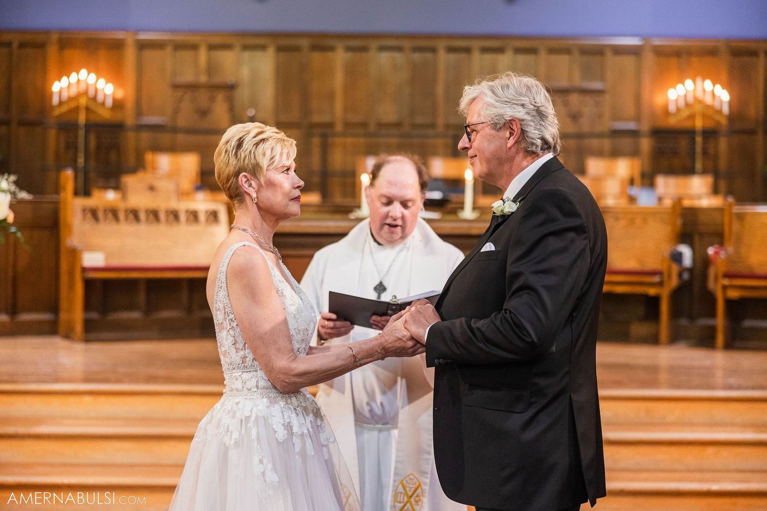 Couple exchanging vows during intimate church wedding ceremony.