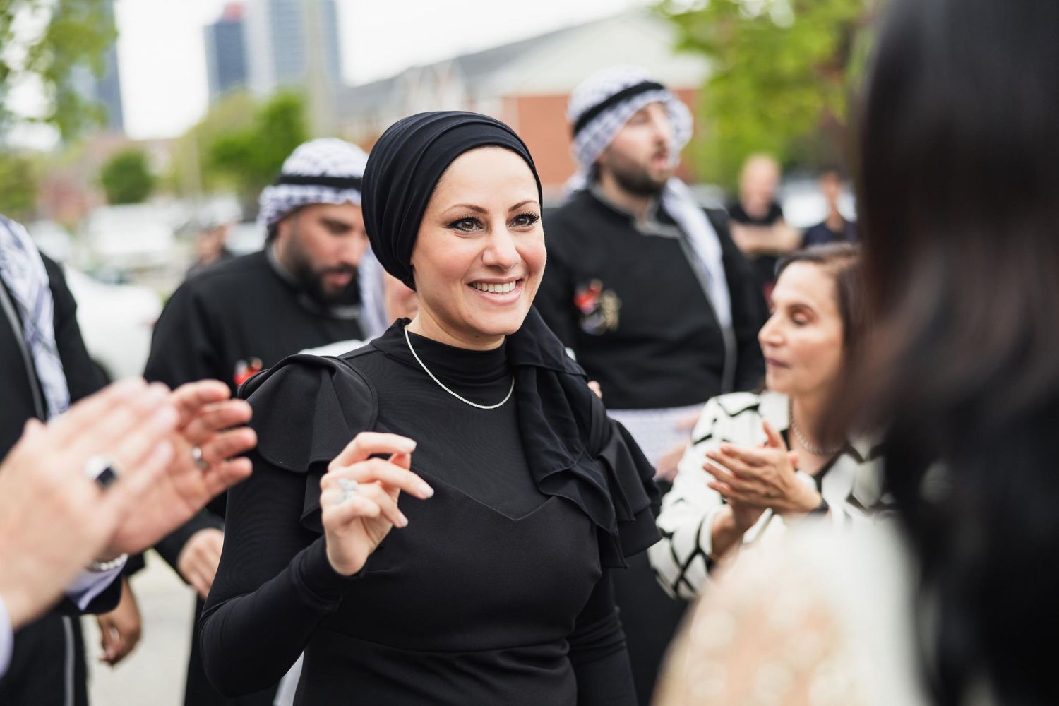 Guests celebrate at a festive outdoor gathering with traditional attire.