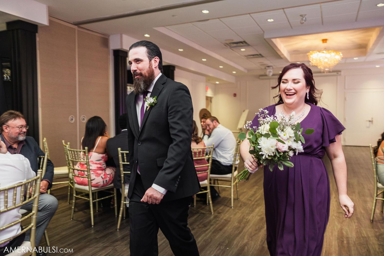 Wedding party members making their grand entrance into the reception hall.