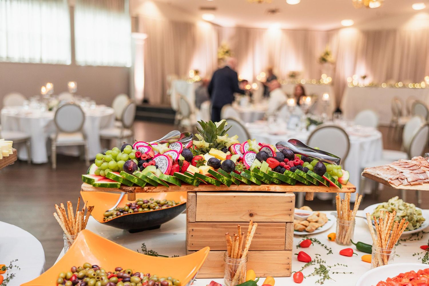 Buffet table with colorful appetizers and hors d'oeuvres at a wedding reception.
