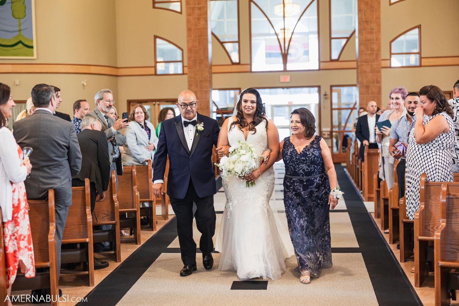 A wedding party processes down the church aisle during a traditional ceremony.