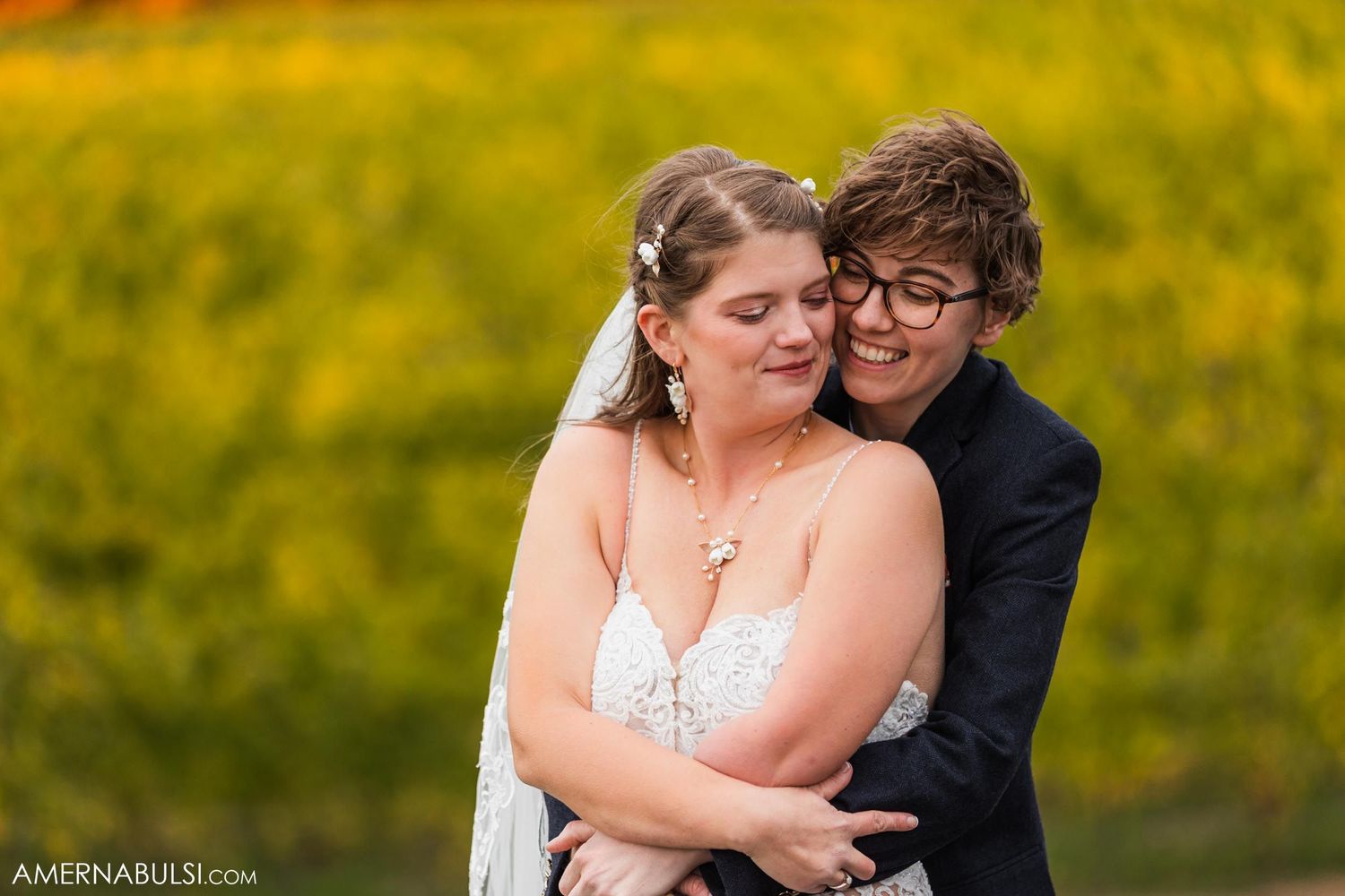 Intimate wedding portrait in front of golden autumn vineyard.