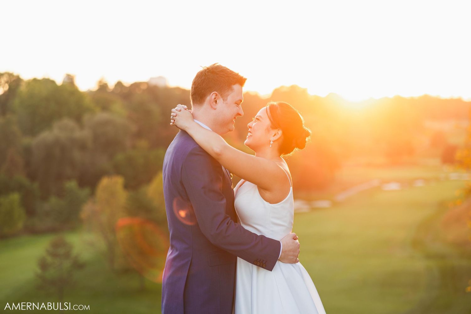 A couple shares an intimate embrace during their sunset wedding photoshoot.
