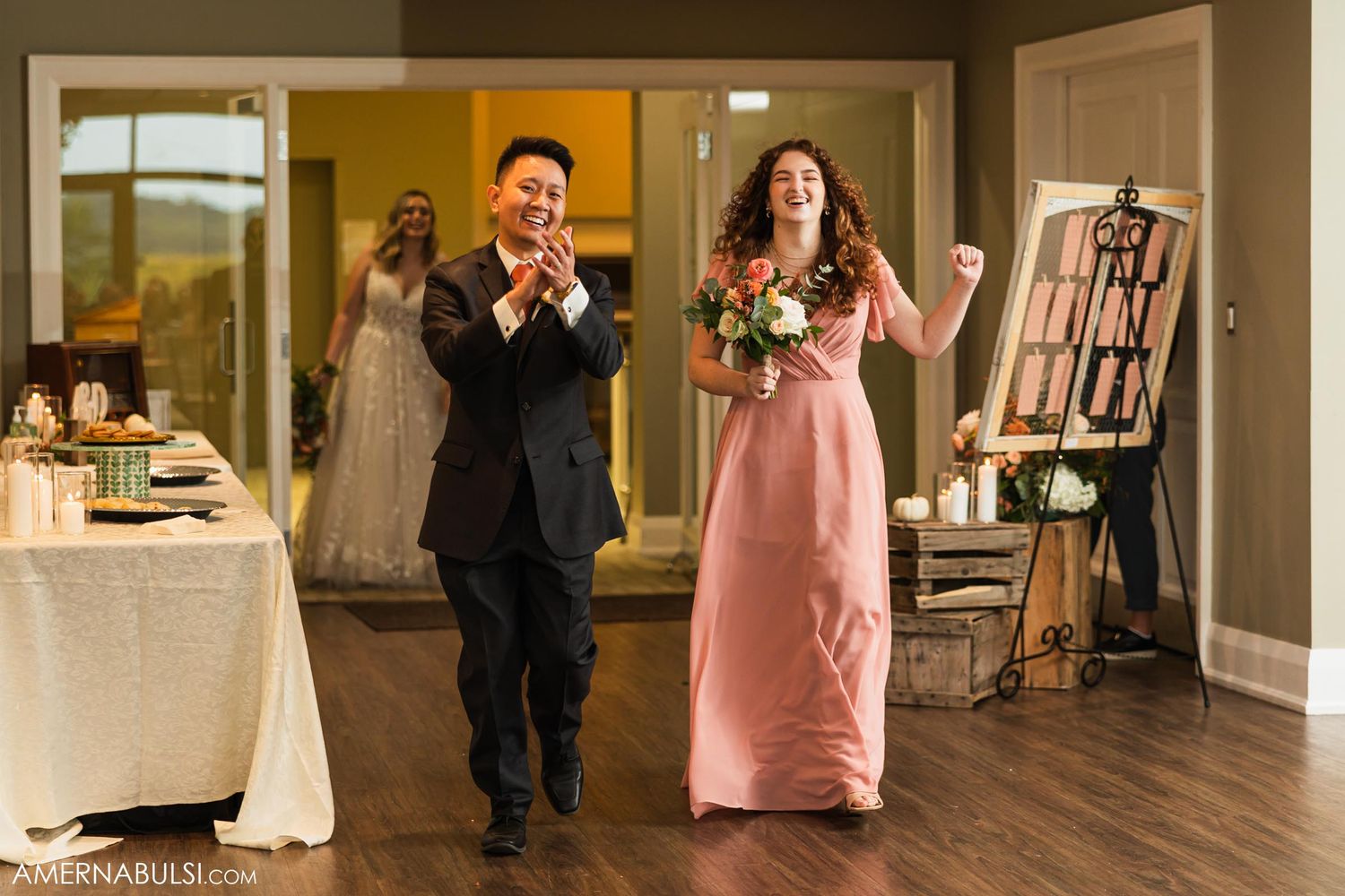 Wedding party members make grand entrance into reception hall.