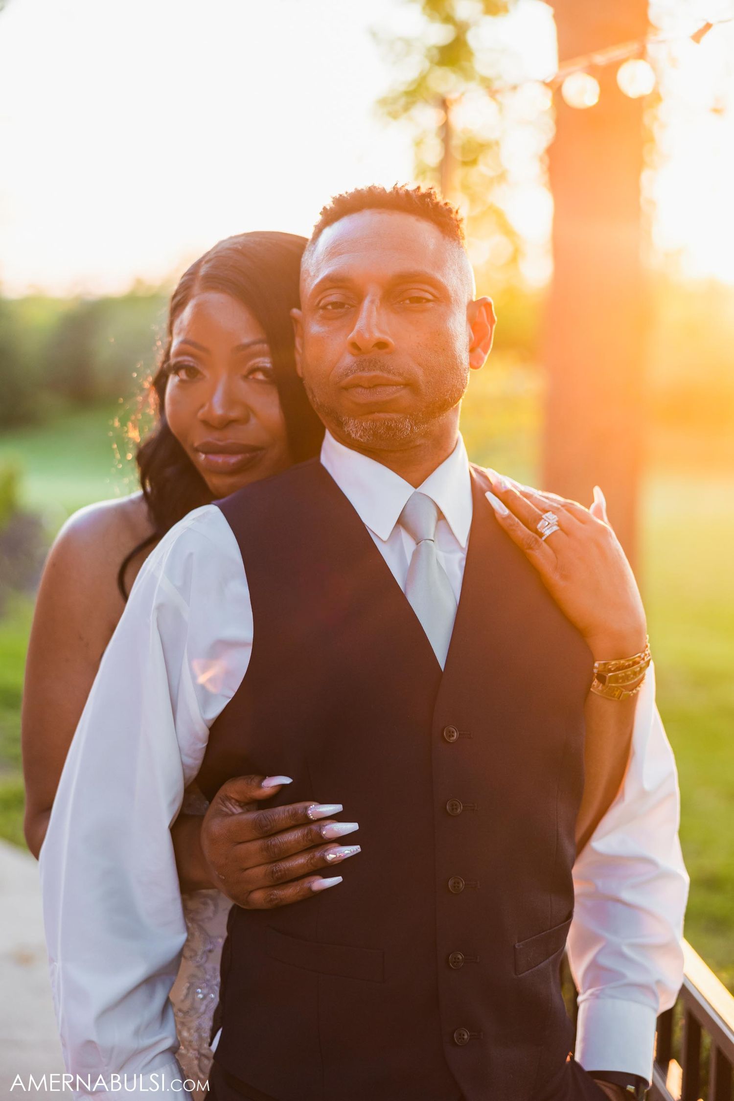 A romantic sunset portrait of a couple in wedding attire.