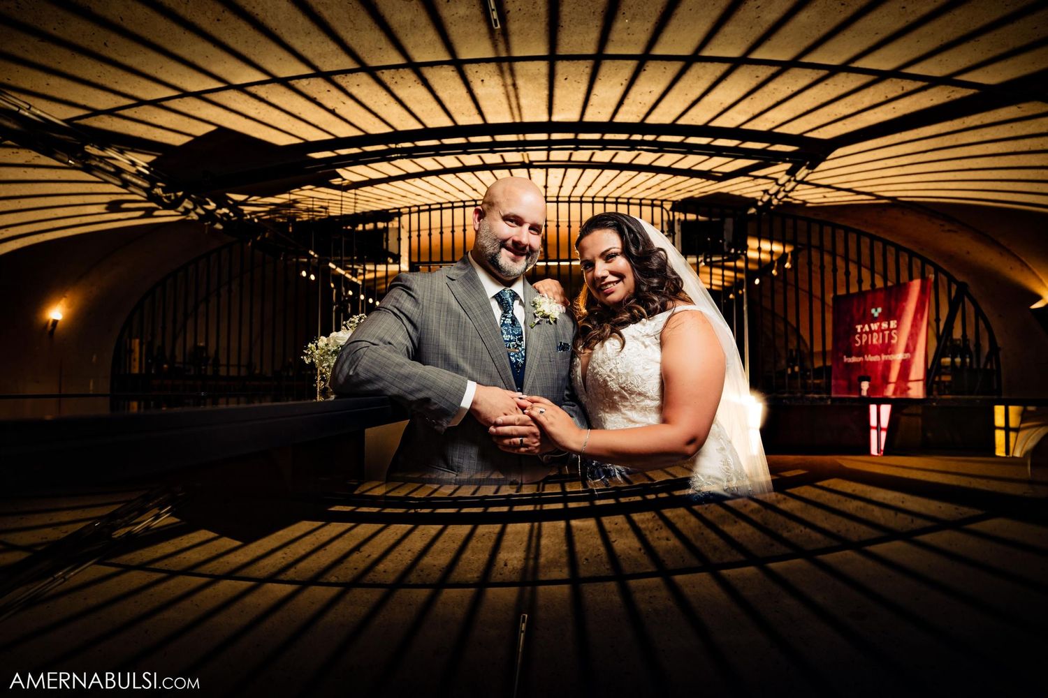 Moody artistic photo of couple at bar with dramatic lighting.