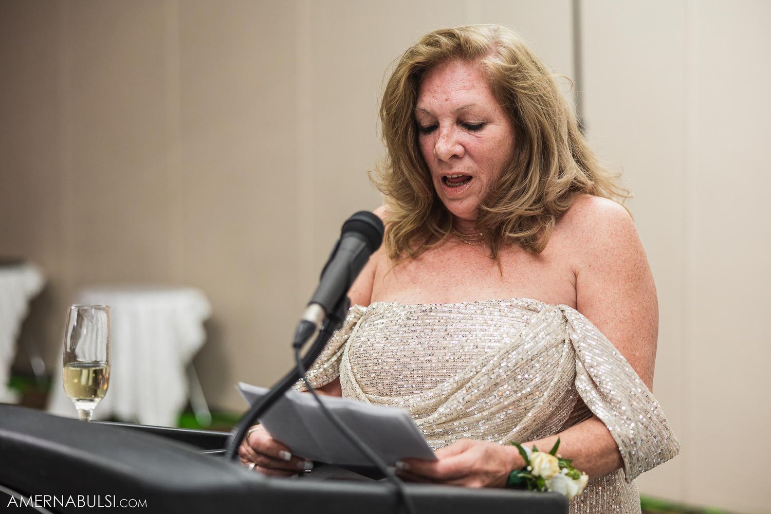 Speaker delivers heartfelt speech at wedding reception microphone.