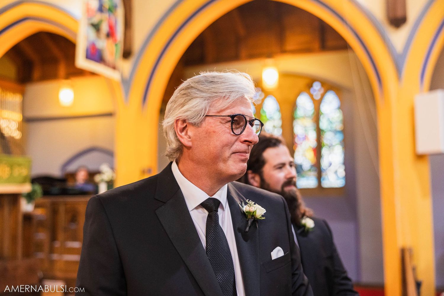 Church ceremony with elegant arched architecture and stained glass windows.