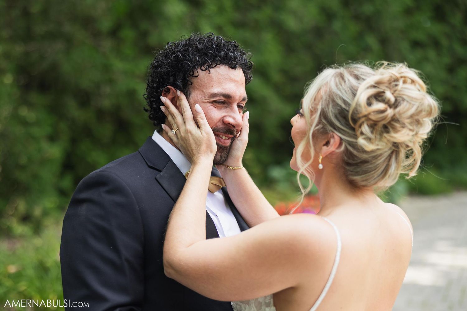 Emotional wedding moment captured between couple during outdoor garden photoshoot.