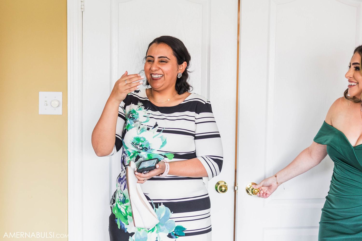 Wedding party members share laughter and excitement during pre-ceremony preparations.