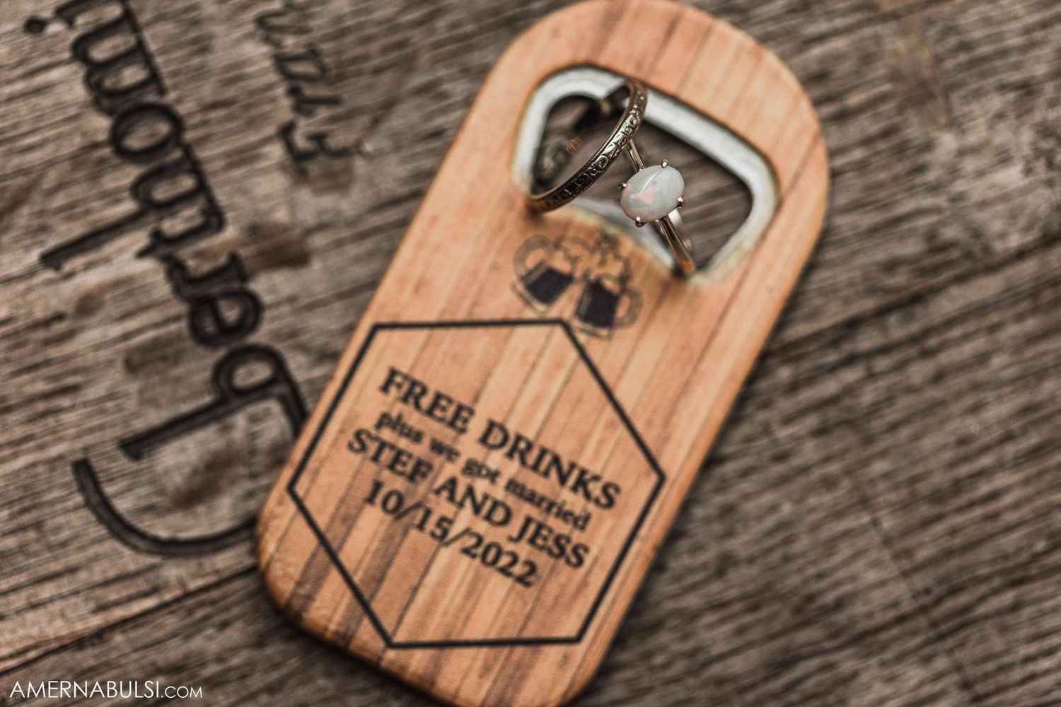 Wooden bottle opener with text engraved on rustic surface.