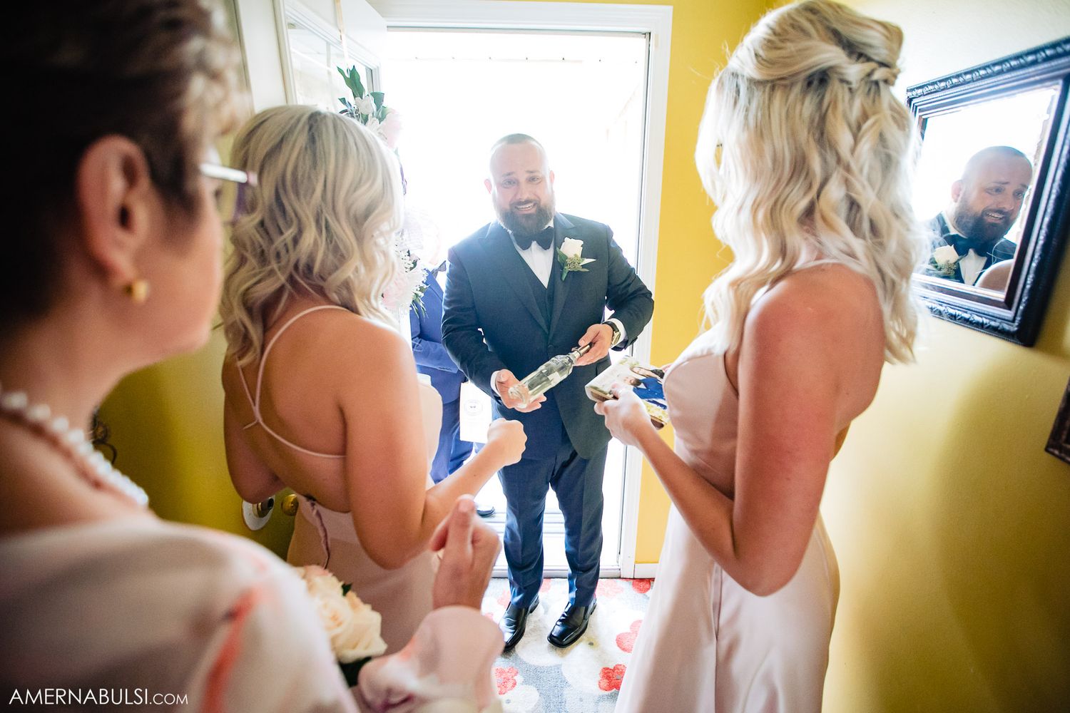 Wedding preparation scene in a bright yellow room with natural window light.
